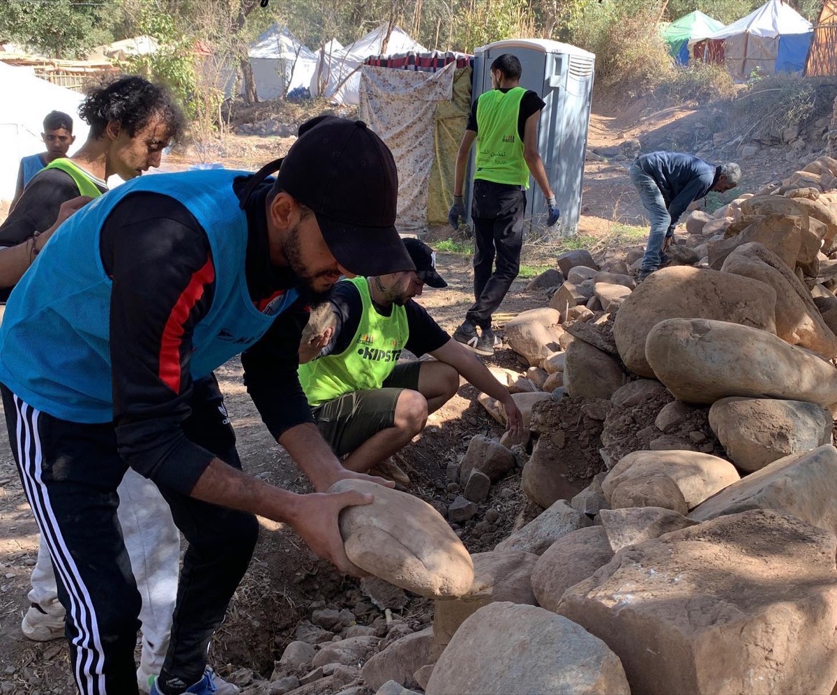 Volunteers clearing rubble for a family